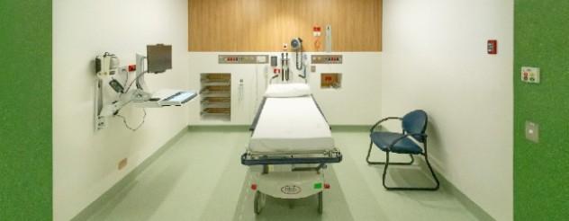 new Emergency department cubicle with one patient bed and a computer terminal on the wall