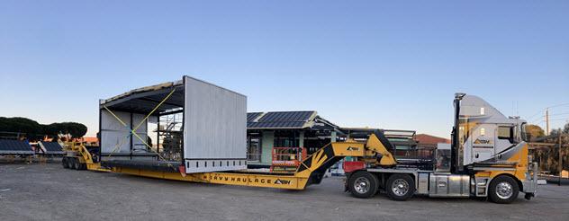 Truck pulls construction module