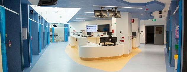 Emergency department with desk in the middle and cubicles either side