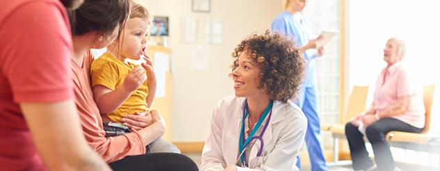 Doctors talk to patients in a waiting room 