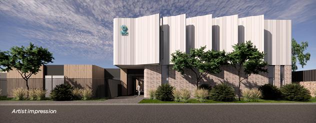 Artist impression of the Northern facade of the Phillip Island Community Hospital. The hospital will be two stories high and the outside is a sandy coastal color. There are native plants surrounding the building.