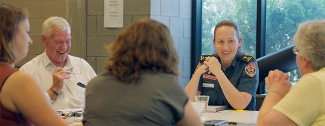 Members of the Melton Hospital Community Consultative Committee sitting around a table talking