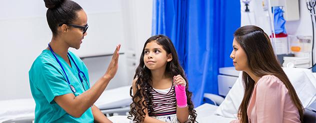 Doctor consults with child and mother at a hospital