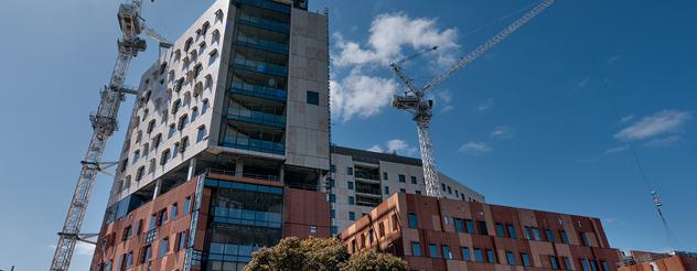 Modern and colourful hospital towers set against a blue sky