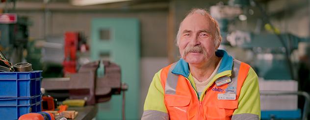 Image of a man, Phil, wearing a fluorescent orange vest and smiling