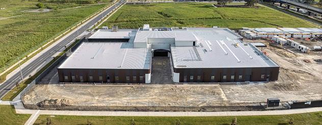 a large grey building provides a blank canvas for the hospital building