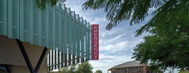 Green and red signage among leafy surrounds